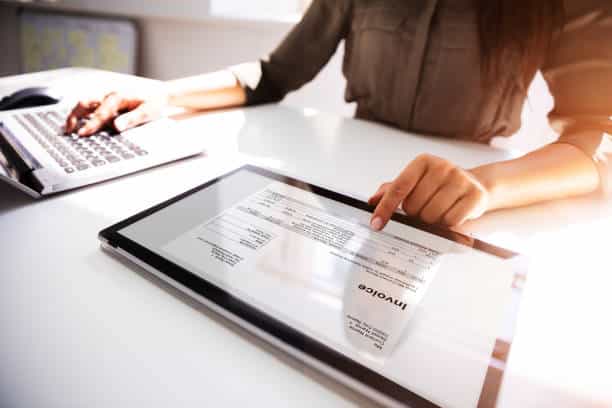 Close Up Of A Busineswoman 039 S Hand Working With Invoice On Digital Tablet